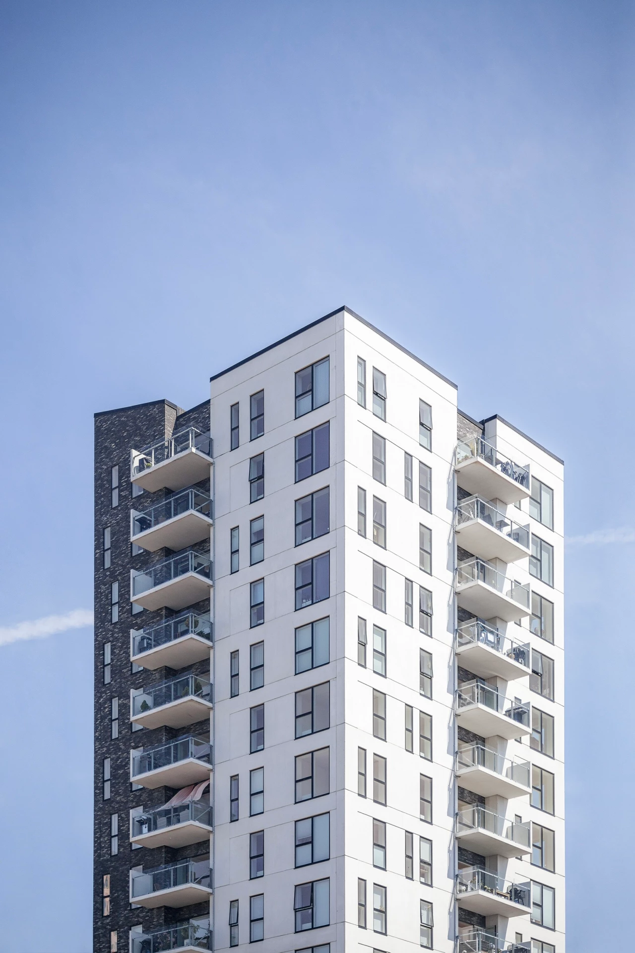 Vertical shot of a white building under the clear sky - alphageo